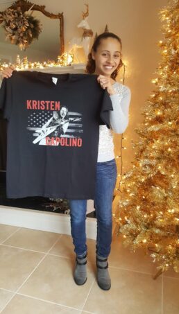 Kristen holding a shirt {{brizy_dc_image_alt imageSrc=
